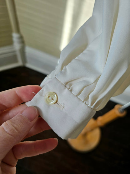 Vintage blouse handmade cream long sleeve v neck pussy bow tie button up front puff sleeves cuffed 70s polyester feminine ladylike dressy casual flowy romantic