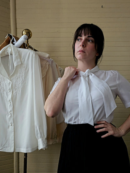 Vintage blouse Paris Station white short sleeves button up front crew neck pussy bow tie rolled collar 70s polyester feminine ladylike granny chic